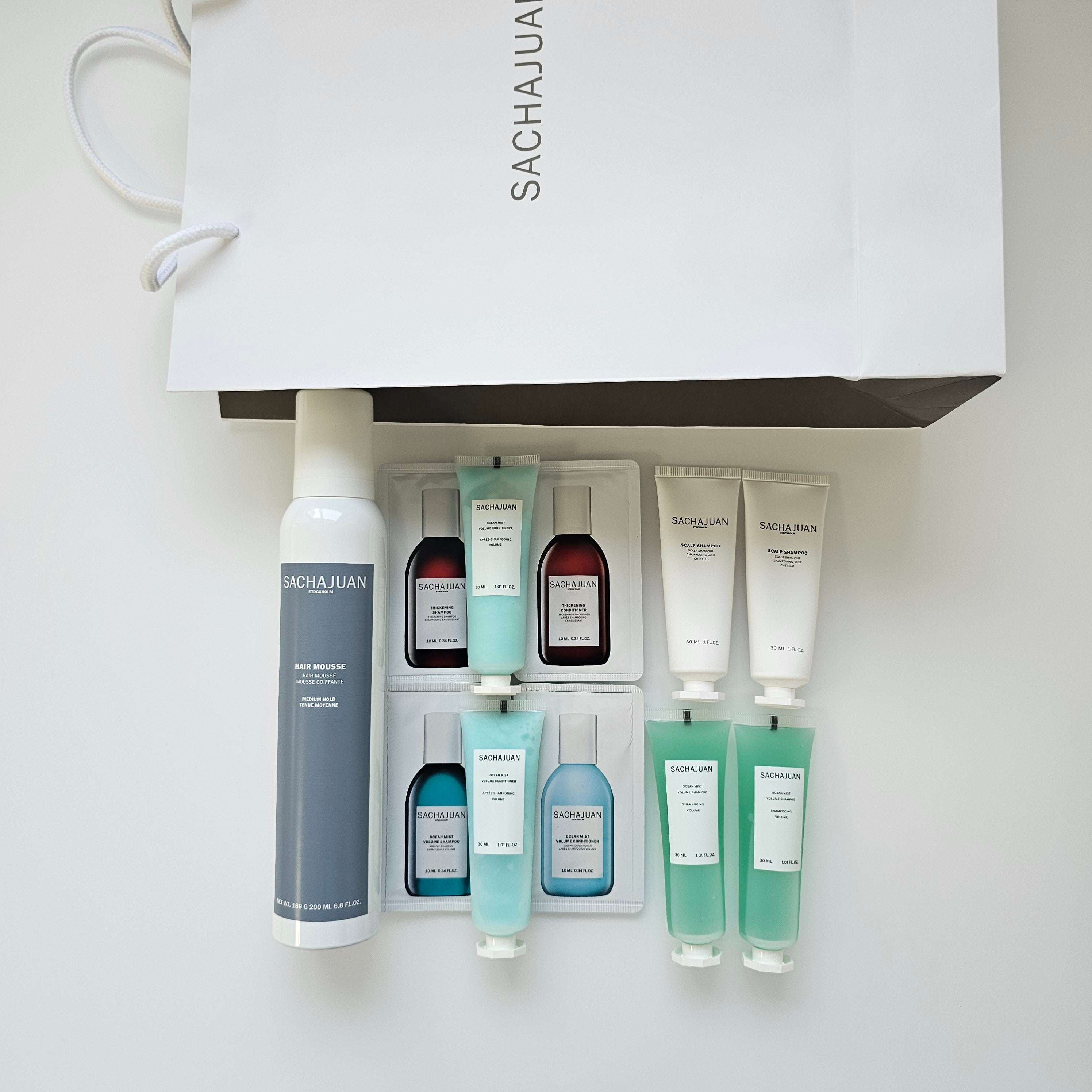 Set of skincare products with a Sachajuan branded bag on a white background - Available in Trnc 